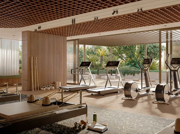 An artist’s impression of the gym and outdoor yoga area at SOL by Walker, with several treadmills and cycling machines looking out towards the full-height glass doors.