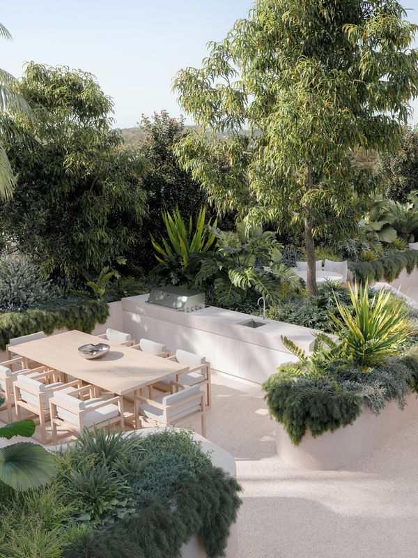 An artist’s impression of the SOL by Walker Sunset Gardens, with a large wooden table and nearby barbeque and cooking facilities surrounded by lush greenery.