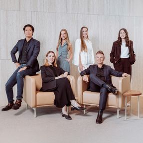 A group of designers and architects seated and standing together.