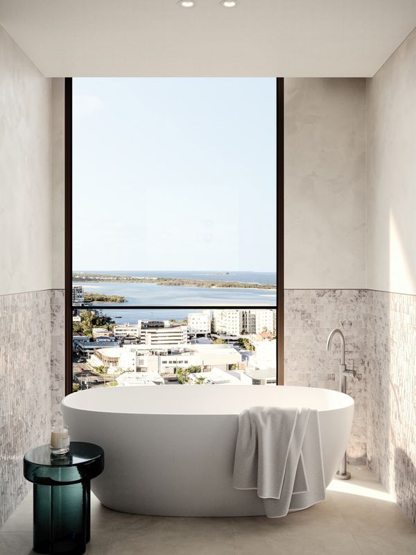 An artist’s impression of the free-standing bathtub in a penthouse at SOL by Walker, looking out through full-height windows over the surrounding Maroochydore area and nearby waterways.