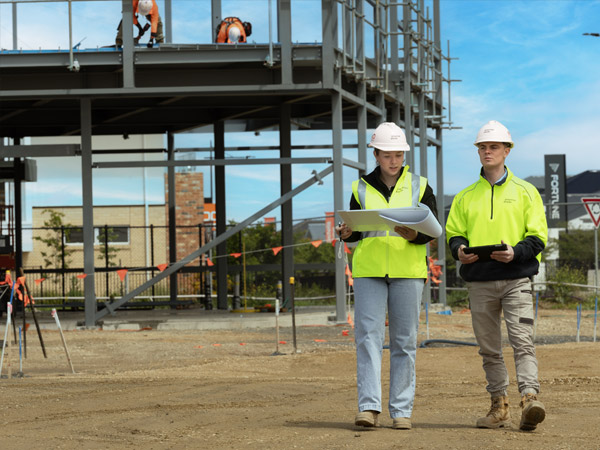 An image of two Payter Dixon team members walking through a construction site.